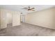 Bedroom with neutral carpet and a ceiling fan, and an open doorway, leading to an additional room at 315 E Marlette Ave, Phoenix, AZ 85012