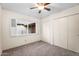 Bedroom with a ceiling fan and closet, complemented by neutral carpet for a comfortable living space at 315 E Marlette Ave, Phoenix, AZ 85012