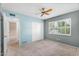 Carpeted bedroom featuring a large closet, a ceiling fan, and a bright window for natural light at 315 E Marlette Ave, Phoenix, AZ 85012