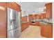 Spacious kitchen featuring wood cabinets, granite counters, and stainless steel appliances at 315 E Marlette Ave, Phoenix, AZ 85012