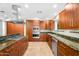 Modern kitchen featuring wooden cabinets, stainless steel appliances, and granite countertops at 315 E Marlette Ave, Phoenix, AZ 85012