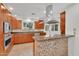 Contemporary kitchen featuring sleek wooden cabinetry, granite countertops, and a stainless steel range hood at 315 E Marlette Ave, Phoenix, AZ 85012