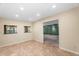 Living room with tile floor, beige walls, and open entrance into a carpeted room at 315 E Marlette Ave, Phoenix, AZ 85012
