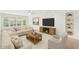 Bright living room features neutral decor, a ceiling fan, and large windows overlooking the landscaped yard at 315 E Marlette Ave, Phoenix, AZ 85012