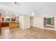 Living room with tile floor, ceiling fan, and open view into the kitchen at 315 E Marlette Ave, Phoenix, AZ 85012
