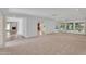 Expansive living area with neutral carpeting and large windows offering bright, natural light at 315 E Marlette Ave, Phoenix, AZ 85012