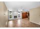 Living room features a brick fireplace, tile floor, and view into the kitchen at 315 E Marlette Ave, Phoenix, AZ 85012