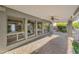 Spacious covered patio featuring brick flooring, ceiling fan, recessed lighting, and access to lush landscaping at 315 E Marlette Ave, Phoenix, AZ 85012
