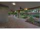 Spacious covered patio features brick flooring, ceiling fans, and views of the landscaped backyard at 315 E Marlette Ave, Phoenix, AZ 85012
