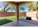 This backyard has a covered patio, artificial turf, a privacy wall and gravel landscaping at 34710 N 27Th Ave, Phoenix, AZ 85086