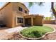 Backyard featuring artificial turf, gravel, covered patio and exterior of home at 34710 N 27Th Ave, Phoenix, AZ 85086