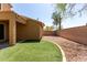 Exterior shot of backyard featuring artificial turf, gravel, exterior of home and block wall at 34710 N 27Th Ave, Phoenix, AZ 85086