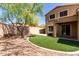Exterior shot of backyard featuring artificial turf, gravel, exterior of home and block wall at 34710 N 27Th Ave, Phoenix, AZ 85086