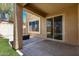 Covered patio featuring tile flooring, with view of artificial turf and block wall at 34710 N 27Th Ave, Phoenix, AZ 85086