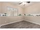 A bedroom with wood-look flooring and an animal themed wallpaper border at 34710 N 27Th Ave, Phoenix, AZ 85086