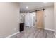 Bedroom featuring modern sliding barn door and light wood floors at 34710 N 27Th Ave, Phoenix, AZ 85086