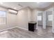 Bright bedroom featuring light wood floors and modern ductless air conditioner at 34710 N 27Th Ave, Phoenix, AZ 85086