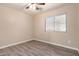Bedroom featuring wood-look floors, a ceiling fan, and a window overlooking the outdoors at 34710 N 27Th Ave, Phoenix, AZ 85086