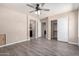 A spacious bedroom with modern wood floors and a ceiling fan, offering ample closet and bathroom access at 34710 N 27Th Ave, Phoenix, AZ 85086
