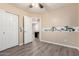 bedroom features wood-look floors, open doorway, closet, and safari themed wallpaper at 34710 N 27Th Ave, Phoenix, AZ 85086