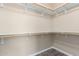 A walk-in closet features wood floors, white walls, and wood shelving, creating ample storage space at 34710 N 27Th Ave, Phoenix, AZ 85086