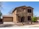 Two-story home featuring desert landscaping, a detached garage, and neutral color palette at 34710 N 27Th Ave, Phoenix, AZ 85086