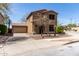 Two-story home featuring desert landscaping, a detached garage, and neutral color palette at 34710 N 27Th Ave, Phoenix, AZ 85086