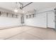 Spacious garage with epoxy flooring, overhead storage racks, and ample room for vehicles at 34710 N 27Th Ave, Phoenix, AZ 85086