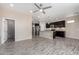 Open concept living area into the kitchen featuring wood-look floors and neutral decor at 34710 N 27Th Ave, Phoenix, AZ 85086