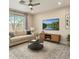 Bright living room featuring a neutral color scheme, large windows, and contemporary furnishings at 34710 N 27Th Ave, Phoenix, AZ 85086