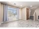 Living room with hardwood style flooring, large window with curtains, and modern lighting at 34710 N 27Th Ave, Phoenix, AZ 85086