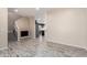 Open-concept living room with wood-look flooring and a view into the kitchen at 34710 N 27Th Ave, Phoenix, AZ 85086