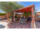Cozy backyard with red brick, a fire pit and outdoor seating under a shaded pergola at 3526 N 85Th St, Scottsdale, AZ 85251