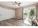 Bedroom with wood floors, closet, and sliding glass doors leading to the pool area at 3526 N 85Th St, Scottsdale, AZ 85251