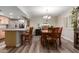 Dining area with plank flooring, modern light fixture, and breakfast bar at 3526 N 85Th St, Scottsdale, AZ 85251