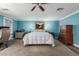 Bright main bedroom featuring plank flooring, ceiling fan, and blue walls at 3526 N 85Th St, Scottsdale, AZ 85251