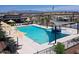 Resort-style community pool featuring a splash pad, sunshades, lounge chairs, and beautiful mountain views at 37049 N Lokai Dr, San Tan Valley, AZ 85140