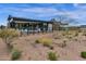 Contemporary home with a well-maintained backyard featuring minimalist landscaping and desert plants at 37200 N Cave Creek Rd # 1013, Scottsdale, AZ 85262