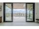 Mountain view from inside home through sliding glass doors to backyard and pool at 37200 N Cave Creek Rd # 1013, Scottsdale, AZ 85262