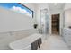 Luxurious bathroom featuring a soaking tub, glass-enclosed shower, and modern cabinetry at 37200 N Cave Creek Rd # 1013, Scottsdale, AZ 85262