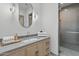 Modern bathroom features a wooden vanity, stylish mirror, and glass-enclosed shower at 37200 N Cave Creek Rd # 1013, Scottsdale, AZ 85262