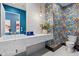 A bathroom showcasing a distinctive wallpaper accent wall and floating vanity at 37200 N Cave Creek Rd # 1013, Scottsdale, AZ 85262