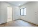 Bright bedroom features wood floors, large window, and closet at 37200 N Cave Creek Rd # 1013, Scottsdale, AZ 85262