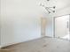 A bright bedroom with hardwood floors, modern light fixture, and large window bringing light into the room at 37200 N Cave Creek Rd # 1013, Scottsdale, AZ 85262