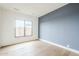 A spacious bedroom featuring hardwood floors, lots of natural light from the window, and two-tone walls at 37200 N Cave Creek Rd # 1013, Scottsdale, AZ 85262