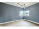 An airy bedroom with unique light fixture, large windows providing outdoor views, and natural light on the hardwood floors at 37200 N Cave Creek Rd # 1013, Scottsdale, AZ 85262