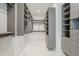 Spacious walk-in closet with custom shelving, drawers, and ample storage space at 37200 N Cave Creek Rd # 1013, Scottsdale, AZ 85262