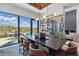 Bright dining area featuring modern lighting, sleek wine storage, and seamless access to outdoor space at 37200 N Cave Creek Rd # 1013, Scottsdale, AZ 85262