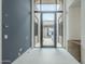 Stunning entryway with high ceilings, gray accent wall, decorative console table, and large glass windows and doors at 37200 N Cave Creek Rd # 1013, Scottsdale, AZ 85262