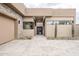 A contemporary home with stone accents and a paved driveway to the entry gate at 37200 N Cave Creek Rd # 1013, Scottsdale, AZ 85262